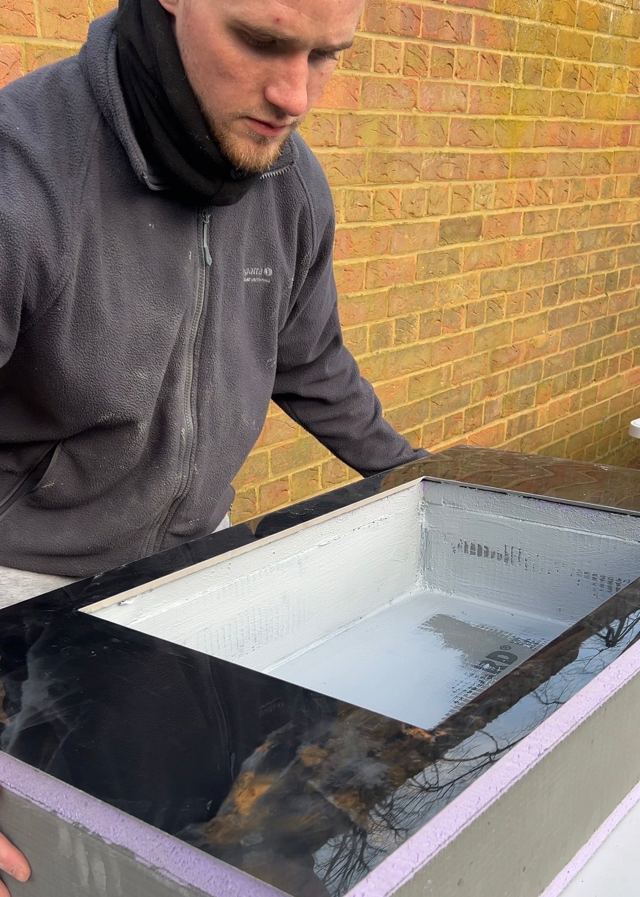 Bespoke black tile basin being built
