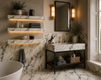 A luxury bathroom interior featuring a marble-look vanity with a black metal frame, matching marble-look floating shelves, a freestanding bathtub edge, and warm wall sconces.