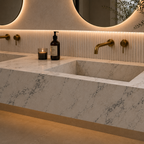 Modern bathroom sink with marble countertop, gold fixtures, and decorative elements.