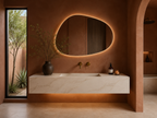 Bespoke wall-mounted floating basin, cream marble effect porcelain, arched bathroom, LED under-lighting, brass tap — Jack the Tiler Studio