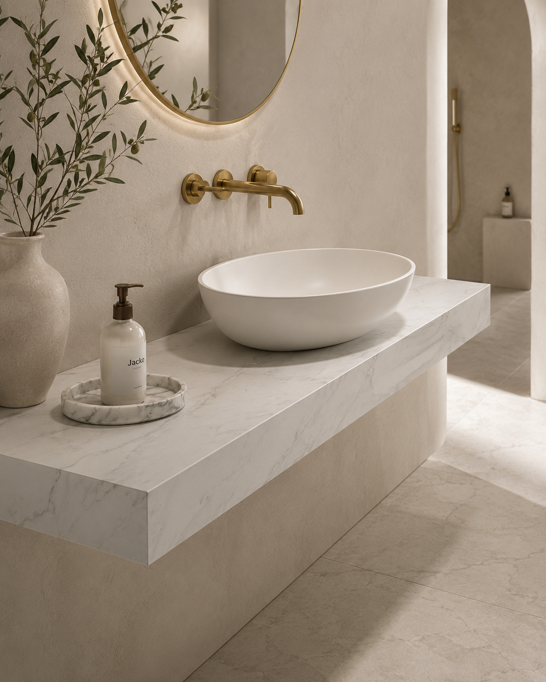 Close-up of a porcelain vanity worktop with a marble-effect vessel basin and brushed brass wall-mounted tap