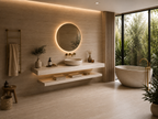 A travertine-effect porcelain vanity worktop and basin in a bathroom with a wooden towel ladder, wicker stool, and freestanding tub by a garden-facing window